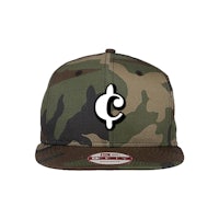 a camouflage snapback hat with the letter c on it